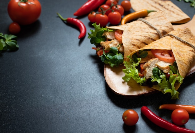 Mexican corn tortilla wrap with grilled chicken and fresh vegetables