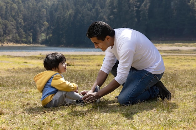 Mexican father and son having fun outdoors