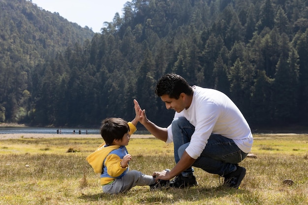 Mexican father and son having fun outdoors