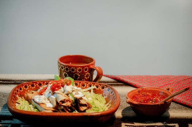 Mexican flautas with lettuce avocado cream sauce and fresh water