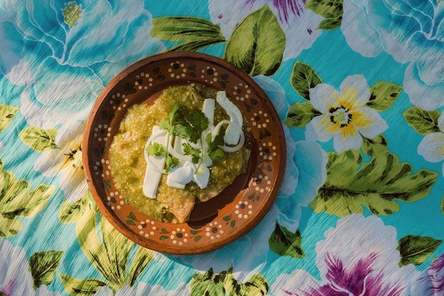 Mexican green enchiladas with chicken cheese cilantro and onion