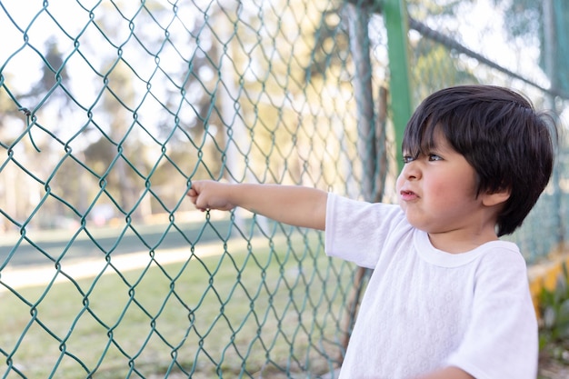 Mexican innocent child playing at fence