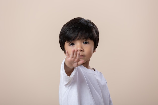 Mexican little boy doing stop sign