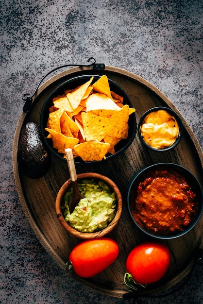 Mexican nachos with guacamole, cheddar cheese and chili. Typical mexican dish