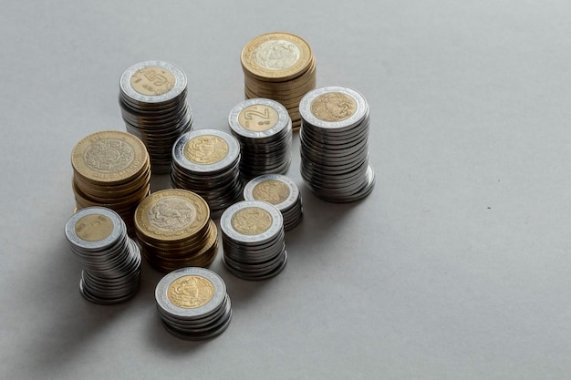 Mexican pesos of different denominations with side lighting on a table with copy space