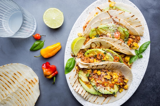 Mexican tacos with meat beans corn and salsa top view