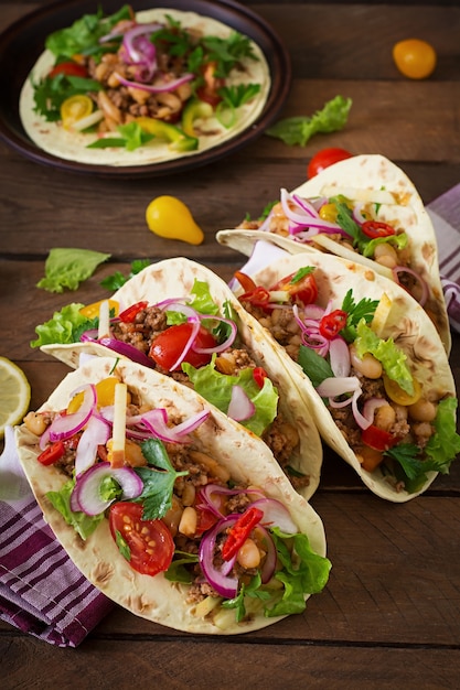 Mexican tacos with meat, beans and salsa