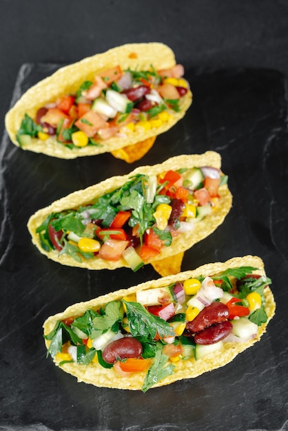 Mexican tacos with vegetables on a dark background on a slate reducetarian flexitarian pescatarian e