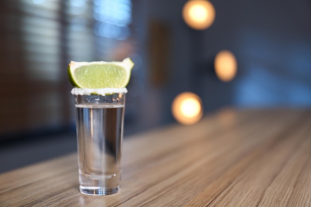 Mexican Tequila with salt and lime slice on bar counter Space for text