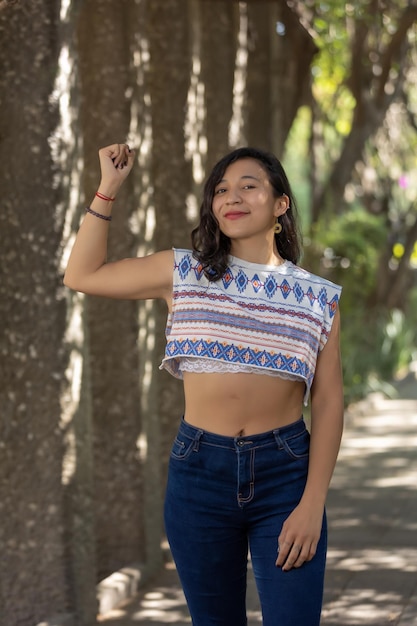 Mexican woman showing biceps outdoors women39s day empowerment