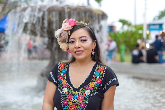 Mexican woman wearing traditional dress with multicolored embroidery celebrating independence day