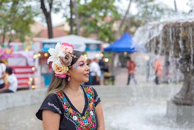 Mexican woman wearing traditional dress with multicolored embroidery celebrating independence day