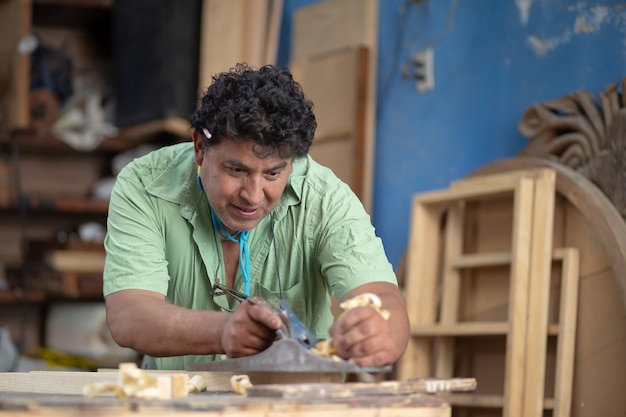 Mexican woodworker, carpenter working in his workshop