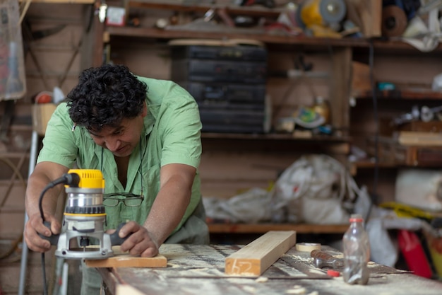 Mexican woodworker, carpenter working in his workshop