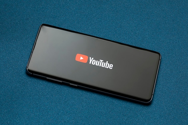 Mexico CDMX April 30 2022 Cell phone on a blue base with YouTube logo on the screen and copy space