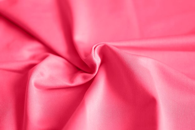 Microfiber fabric pink color background with pleats top view toned in viva magenta trend color of the year 2023