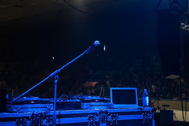 Microphone in concert hall with blue lights