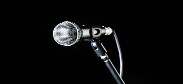 Microphone, mic, karaoke, concert, voice music. Closeup microphone. Vocal audio mic on a bleck background. Live music, audio equipment. Karaoke concert, sing sound. Singer in karaokes, microphones.