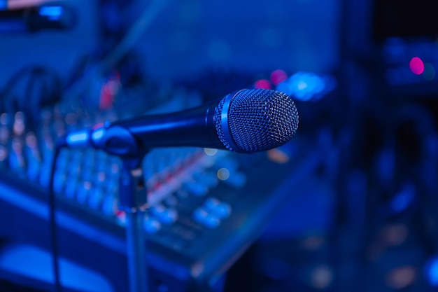 Microphone Microphone on the blurred background of the audio mixer of the musician Night show