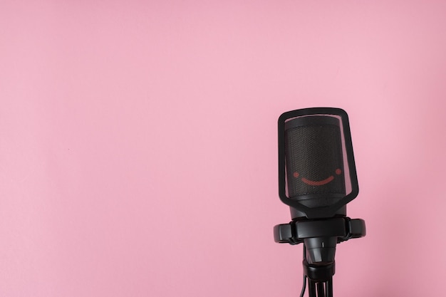 Microphone on a pink background with space for text