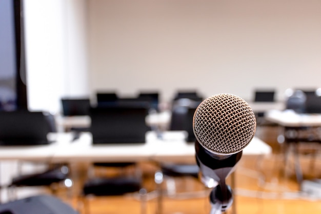 Microphone with laptop on table background in seminar room