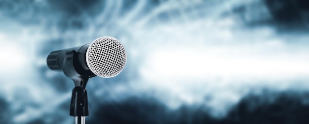 Microphone with stage light background for performance concept of speech comment and public speaking