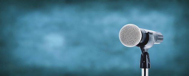 Microphone with stage light background for performance concept of speech comment and public speaking