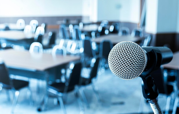 Microphone with tripod on stage in seminar room and copy space