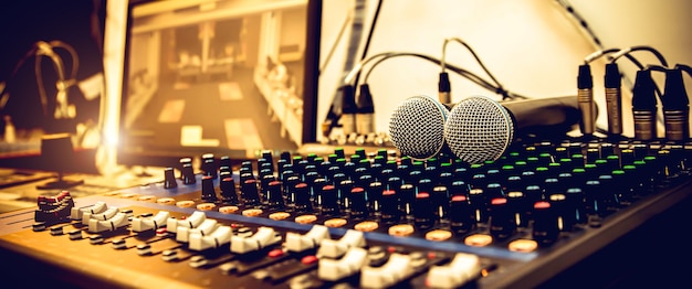 Microphones with sound mixer in studio.