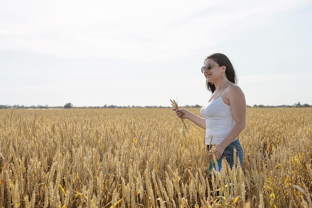 Mid adult woman walking on rye field enjoying nature