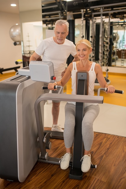 Mid-aged man and a woman having a workout in the gym