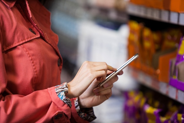 Mid section of woman using mobile phone