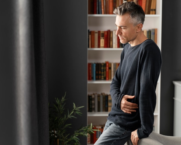 Mid shot worried man in therapy office