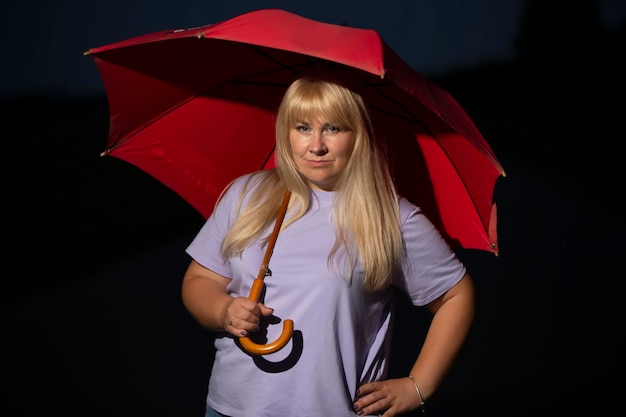 Middle age blonde woman under umbrella