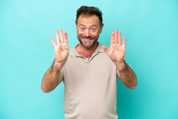 Middle age caucasian man isolated on blue background counting nine with fingers