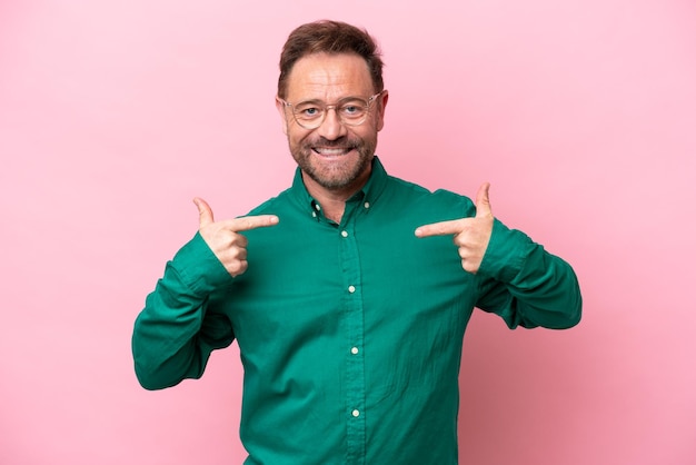 Middle age caucasian man isolated on pink background giving a thumbs up gesture