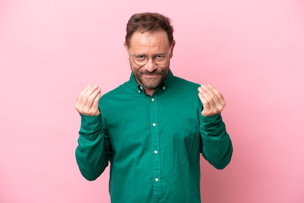 Middle age caucasian man isolated on pink background