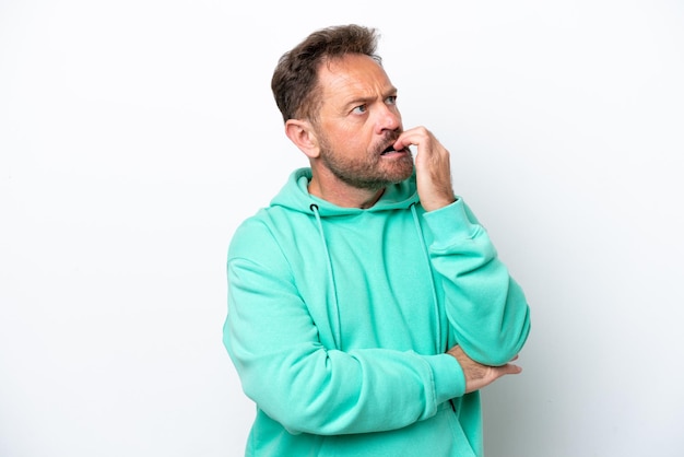 Middle age caucasian man isolated on white background is a little bit nervous