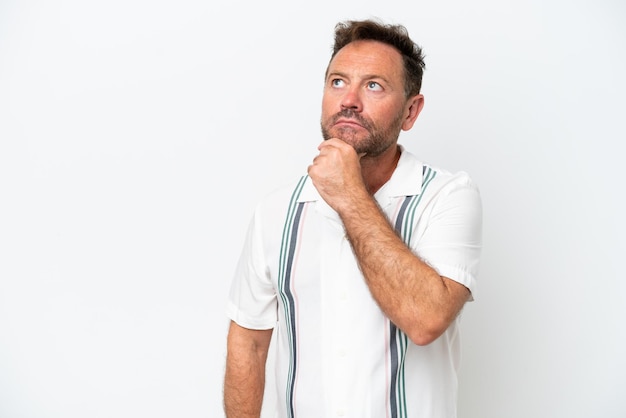 Middle age caucasian man isolated on white background looking up while smiling