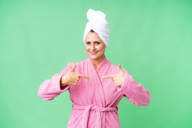 Middle age caucasian woman in a bathrobe over isolated background proud and selfsatisfied