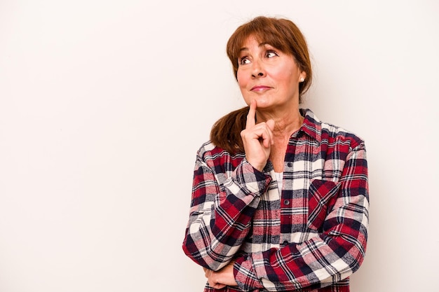 Middle age caucasian woman isolated on white background looking sideways with doubtful and skeptical expression