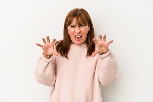 Middle age caucasian woman isolated on white background showing claws imitating a cat, aggressive gesture.