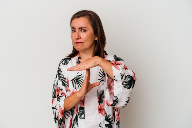 Middle age caucasian woman isolated on white background showing a timeout gesture.