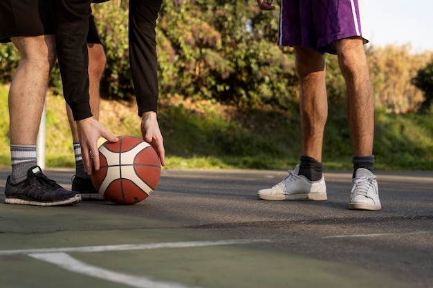 Middle age friends having fun together playing basketball