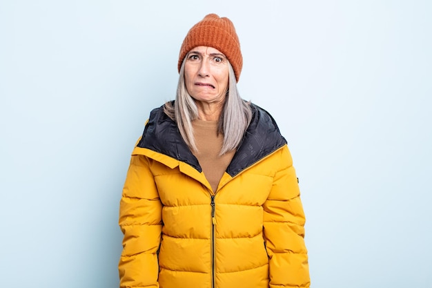 Middle age gray hair woman looking puzzled and confused. cold weather concept