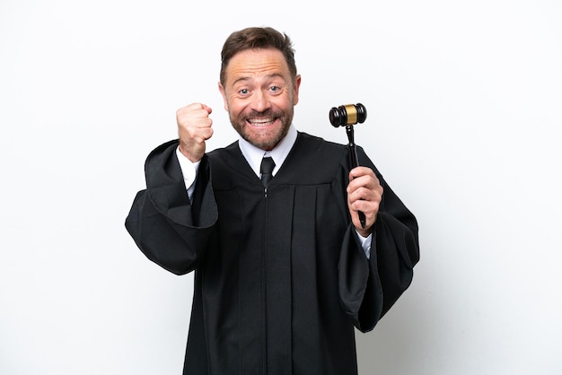 Middle age judge man isolated on white background celebrating a victory in winner position