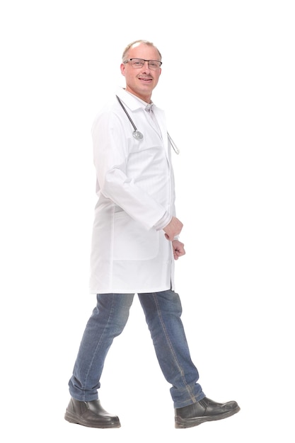 Middle age male doctor walking away and look at camera isolated on white