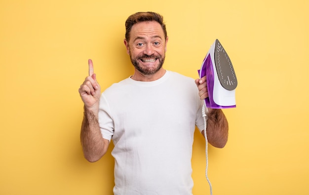 Middle age man feeling like a happy and excited genius after realizing an idea. clothes iron concept