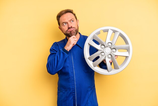 Photo middle age man thinking feeling doubtful and confused car mechanic concept