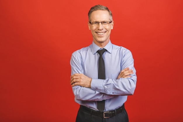 Middle age senior hoary senior man wearing glasses happy face smiling with crossed arms